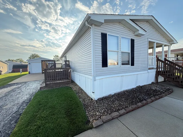 a view of a house with a yard and sitting area