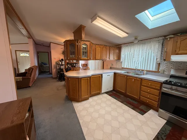 a kitchen with a sink stove and cabinets