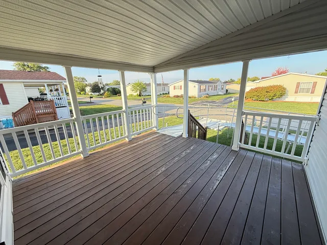 a view of a balcony with wooden floor