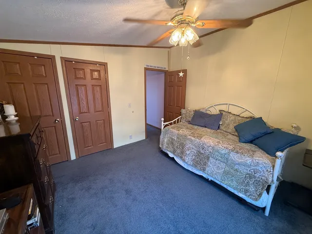 a bedroom with a bed and a chandelier