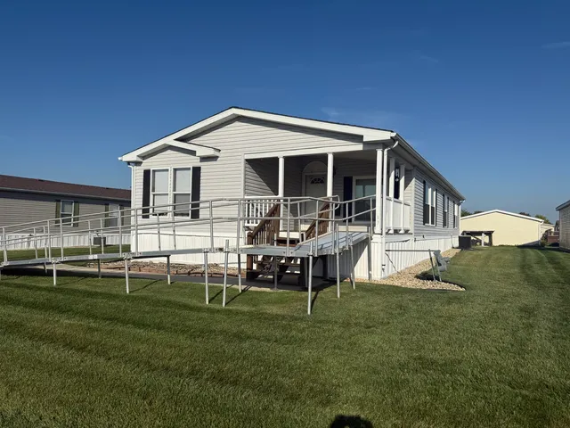 a front view of a house with a yard table and chairs