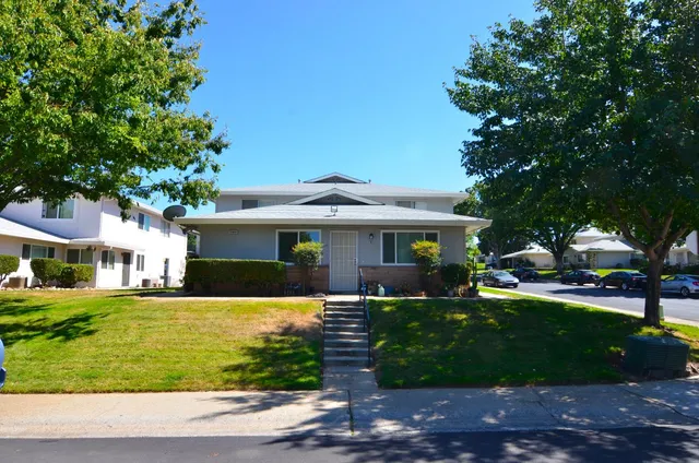 a front view of a house with a yard