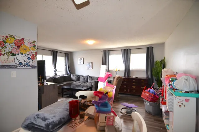 a living room filled with furniture and a window