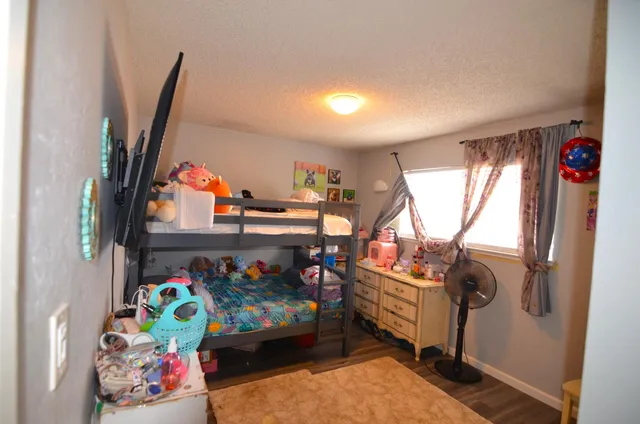 a bedroom with baby crib and hanging chair
