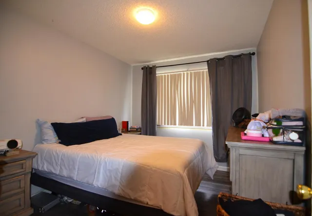 a bedroom with a bed and a window