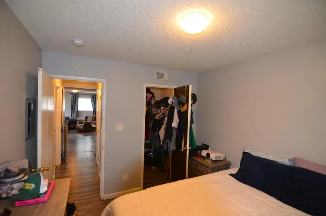 a bed room with a bed and a mirror