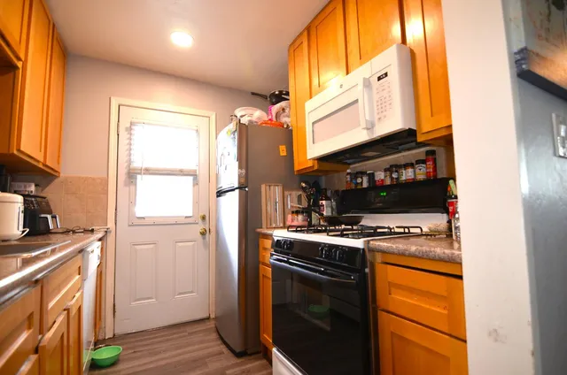 a kitchen with stainless steel appliances granite countertop a stove and a refrigerator