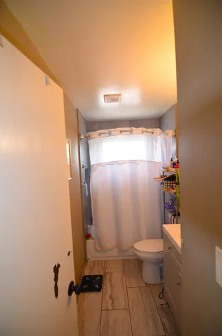 a bathroom with a toilet and a shower