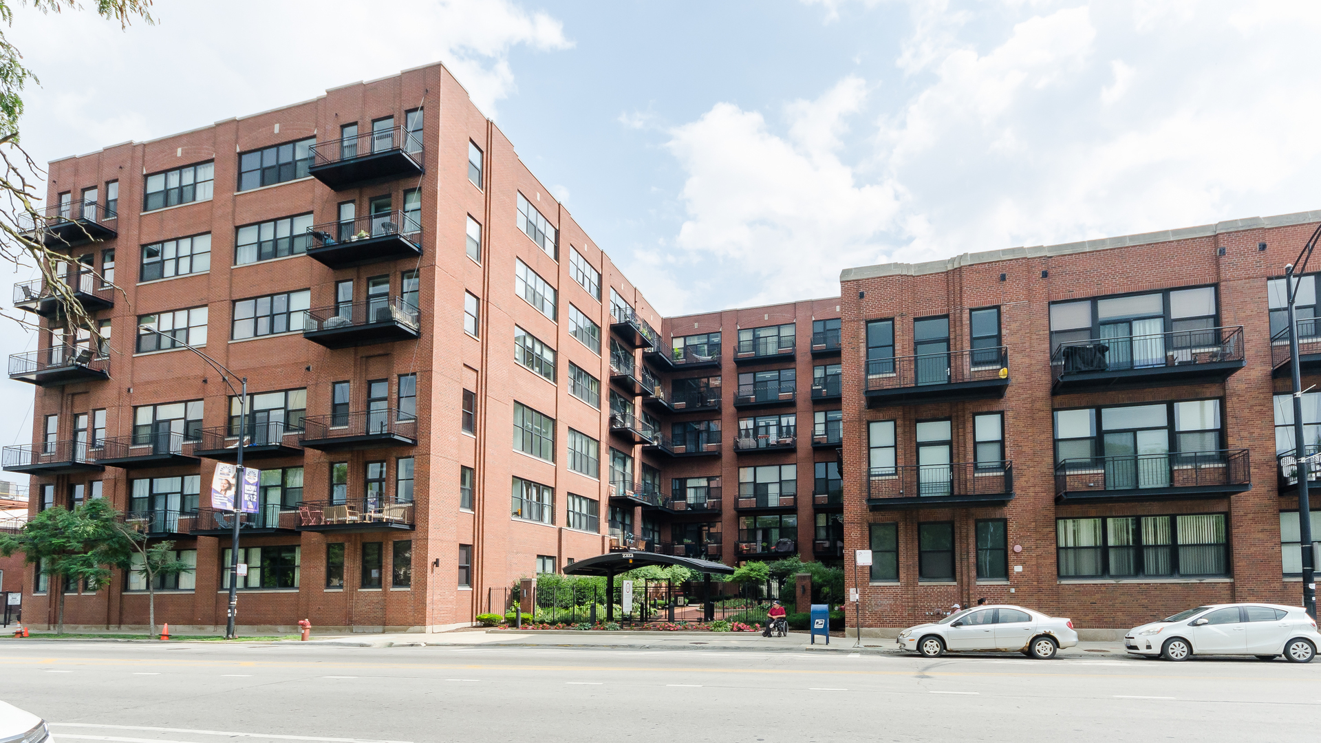 2323 West Pershing Road, Unit 602 Chicago, IL 60609 - Photo 1 of 29 a front view of a building with lot of cars and trees