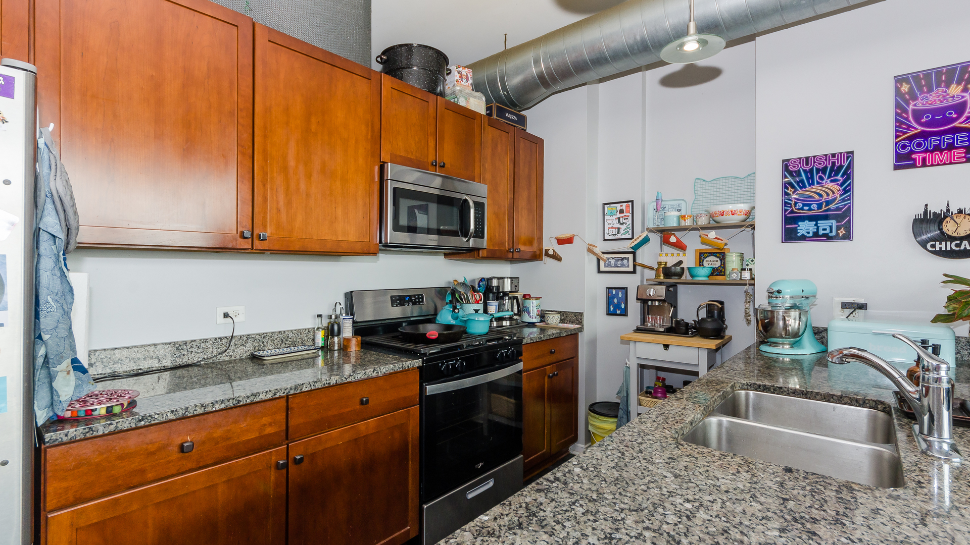 2323 West Pershing Road, Unit 602 Chicago, IL 60609 - Photo 12 of 29 a kitchen with stainless steel appliances granite countertop a sink stove and microwave