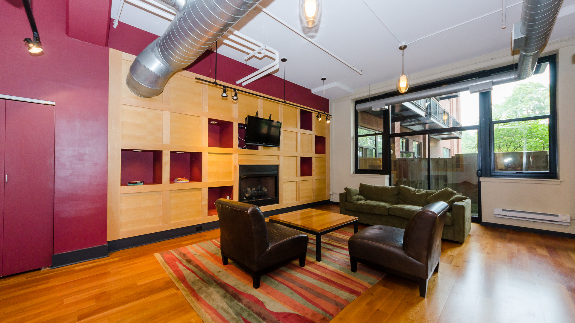 2323 West Pershing Road, Unit 602 Chicago, IL 60609 - Photo 4 of 29 a living room with fireplace furniture and a floor to ceiling window