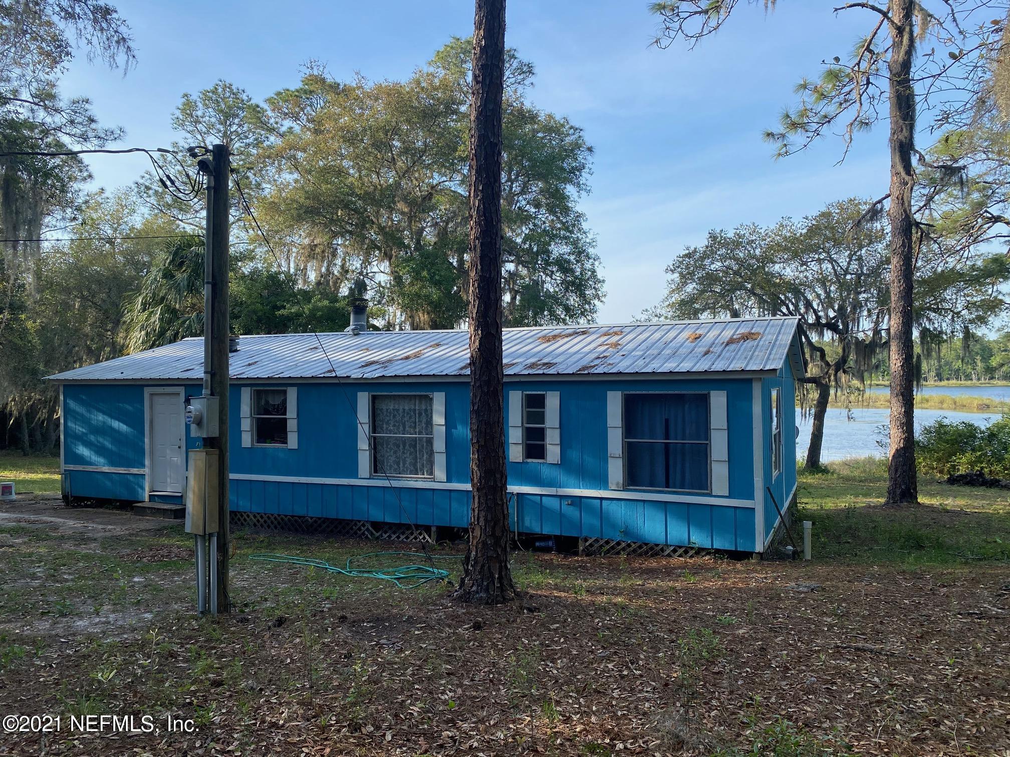 196 Indian Lakes Road Hawthorne, FL 32640 - Photo 1 of 27 a view of a house with a yard and tree s