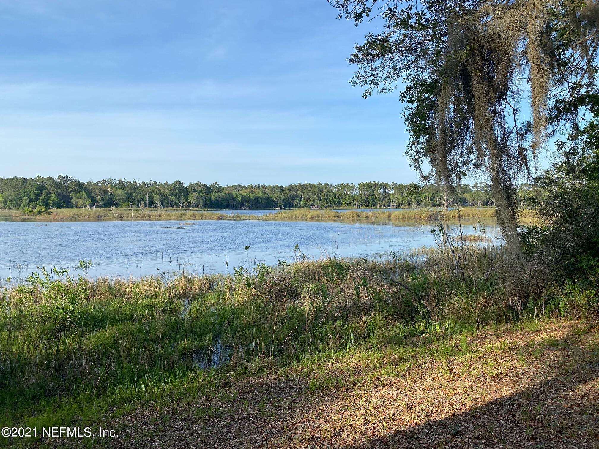 196 Indian Lakes Road Hawthorne, FL 32640 - Photo 12 of 27 a view of a lake from a yard