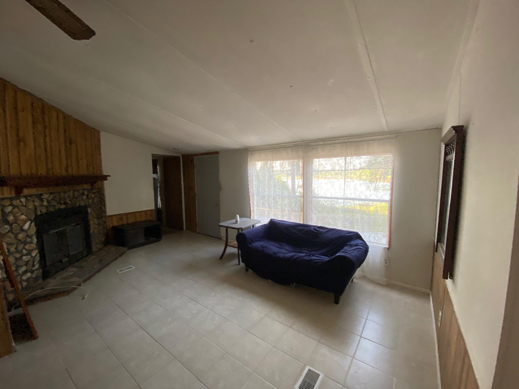 196 Indian Lakes Road Hawthorne, FL 32640 - Photo 19 of 27 a living room with a fireplace and a window