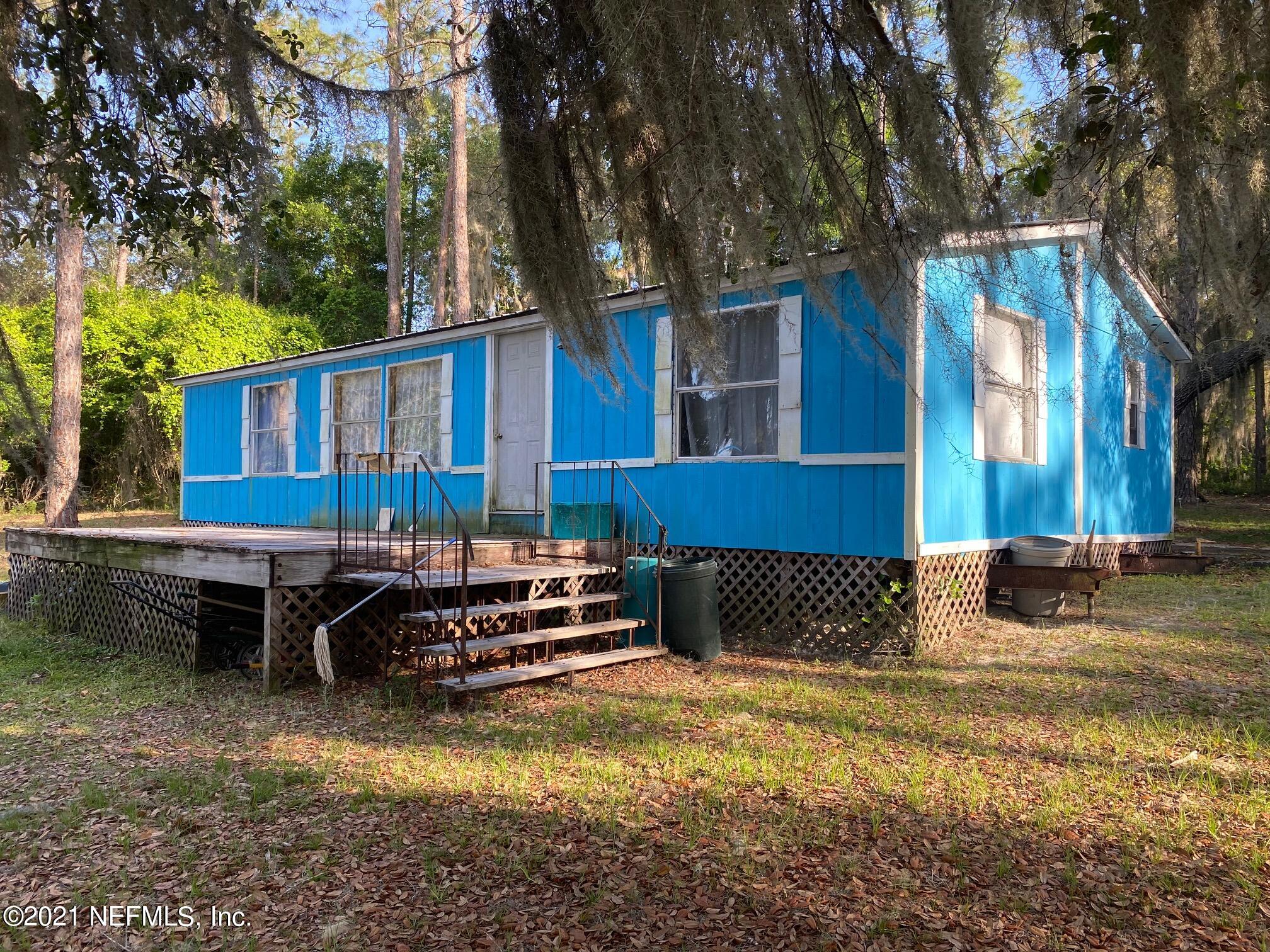 196 Indian Lakes Road Hawthorne, FL 32640 - Photo 2 of 27 a front view of a house with swimming pool and sitting area