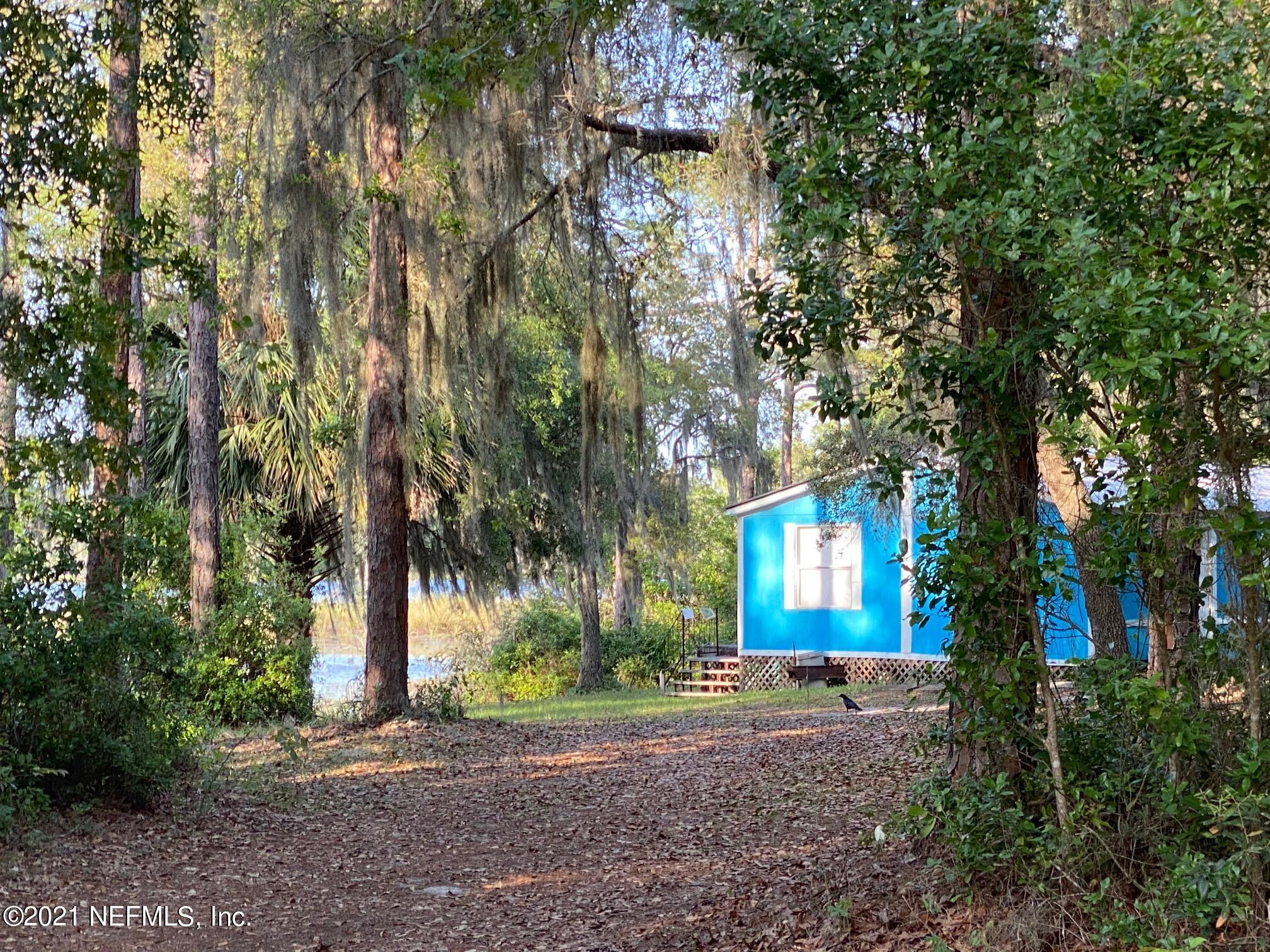 196 Indian Lakes Road Hawthorne, FL 32640 - Photo 3 of 27 a house with lots of trees