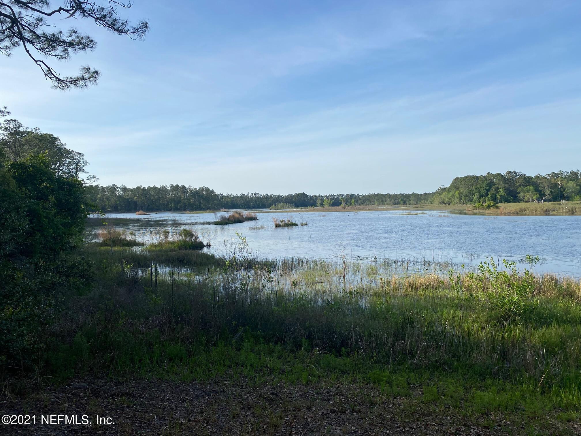 196 Indian Lakes Road Hawthorne, FL 32640 - Photo 10 of 27 a view of a lake and green valley