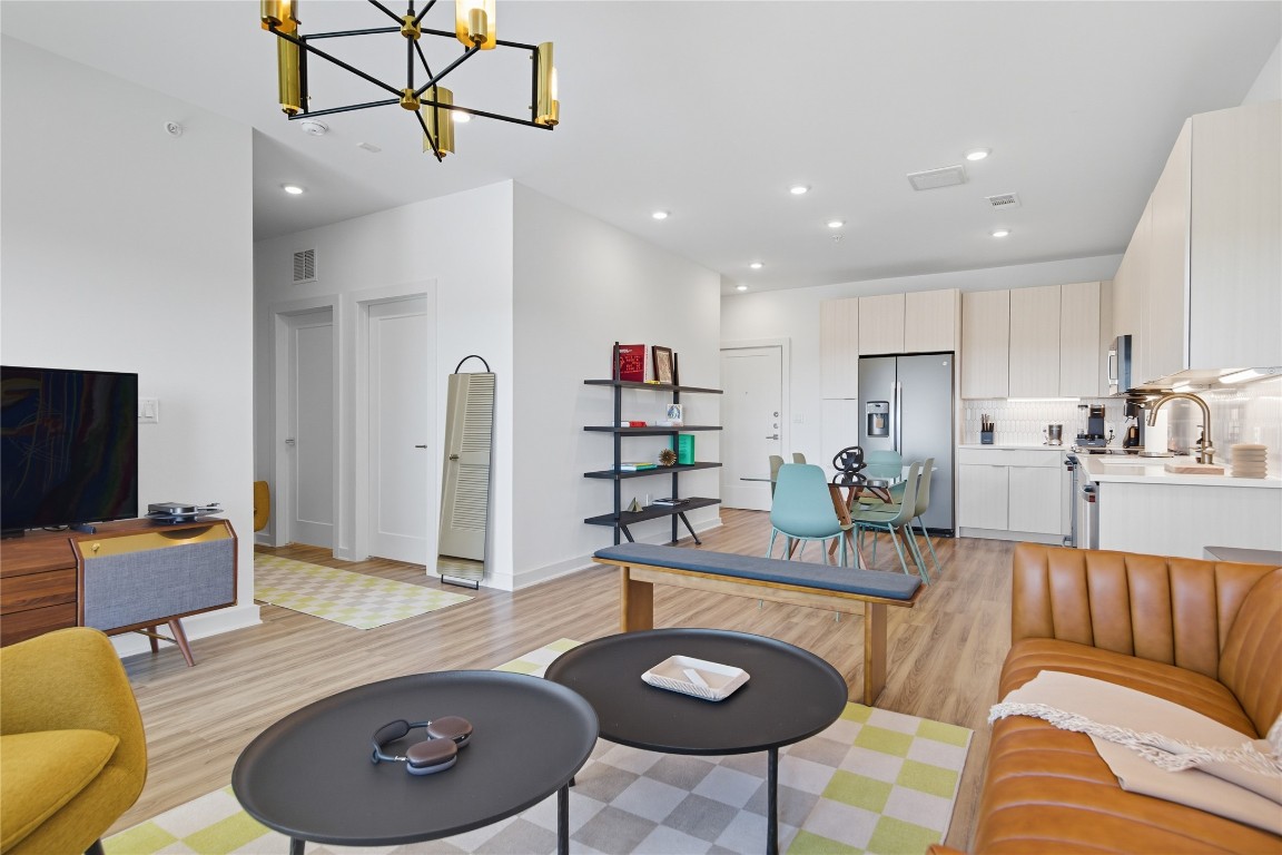 4802 South Congress Avenue, Unit 507 Austin, TX 78745 - Photo 13 of 30 Living area with light wood-type flooring, a chandelier, and recessed lighting
