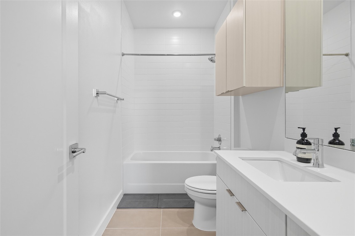 4802 South Congress Avenue, Unit 507 Austin, TX 78745 - Photo 17 of 30 Full bath featuring vanity, light tile patterned floors, and shower combination