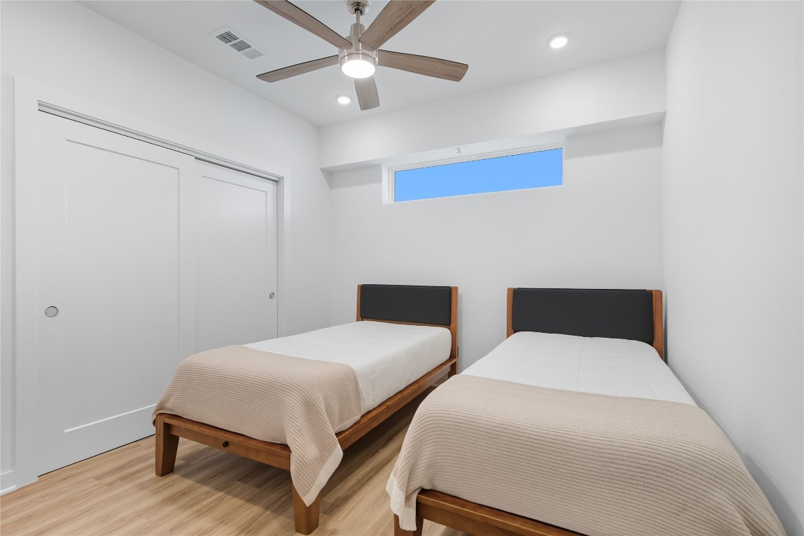 4802 South Congress Avenue, Unit 507 Austin, TX 78745 - Photo 18 of 30 Bedroom featuring wood finished floors, ceiling fan, recessed lighting, and a closet