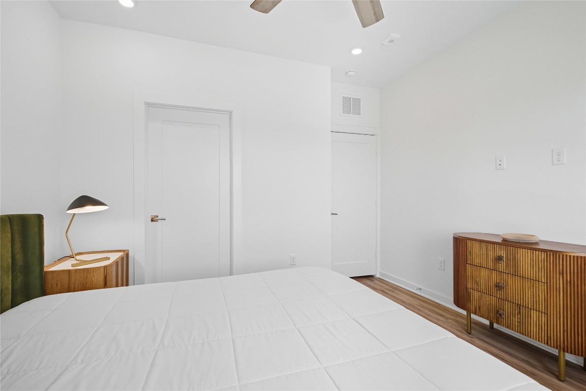 4802 South Congress Avenue, Unit 507 Austin, TX 78745 - Photo 21 of 30 Bedroom featuring wood finished floors, a ceiling fan, and recessed lighting