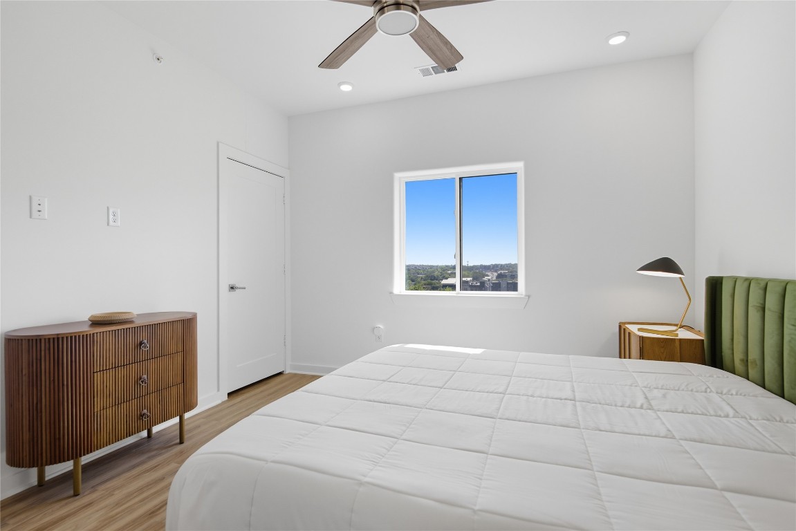 4802 South Congress Avenue, Unit 507 Austin, TX 78745 - Photo 23 of 30 Bedroom with light wood finished floors, ceiling fan, and recessed lighting