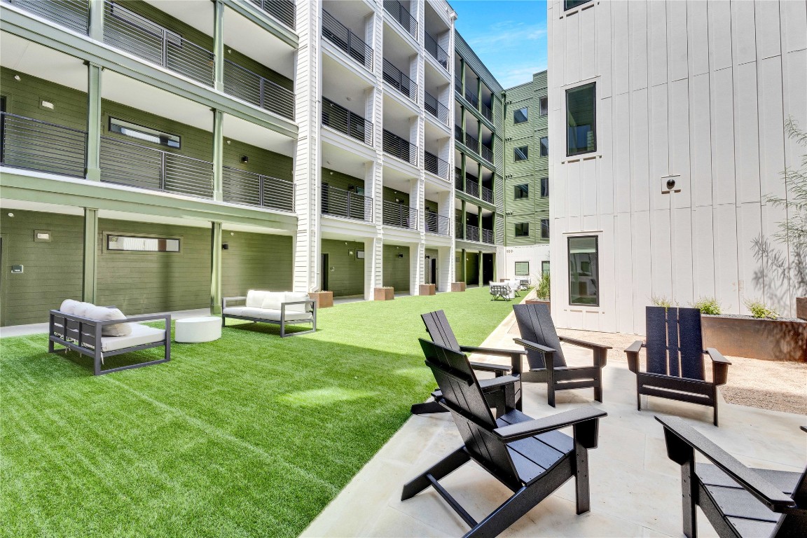 4802 South Congress Avenue, Unit 507 Austin, TX 78745 - Photo 26 of 30 View of property's community featuring outdoor lounge area, a lawn, and a patio