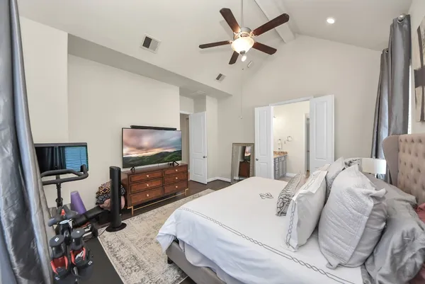 a bedroom with a large bed and a large window