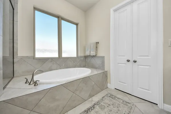 a spacious bathroom with a bathtub and a sink