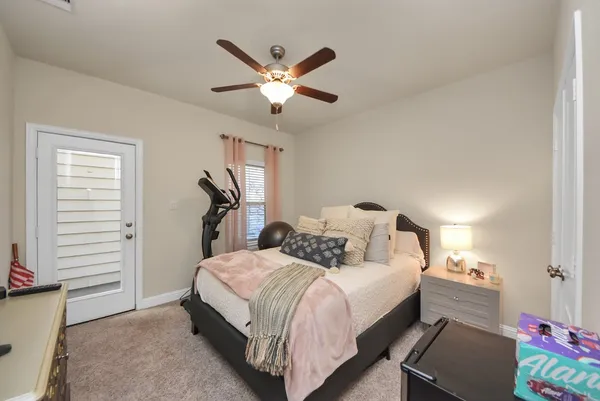 a spacious bedroom with a bed and a chandelier