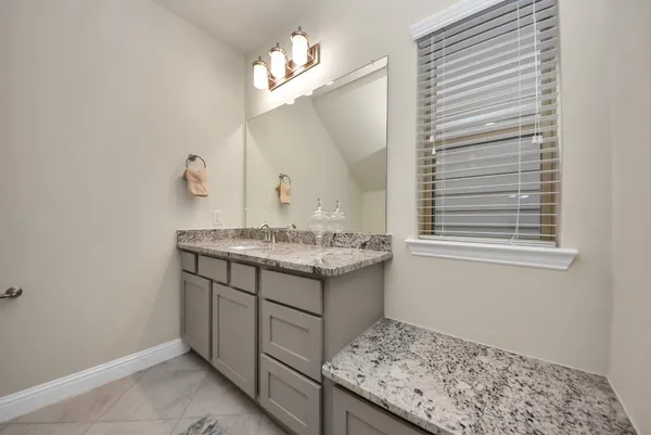 a bathroom with a sink a vanity and a mirror