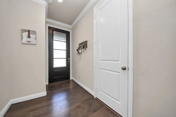 a kitchen with stainless steel appliances granite countertop a table chairs refrigerator and microwave