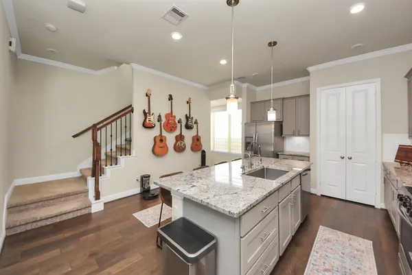 a large kitchen with kitchen island granite countertop a large counter top and sink