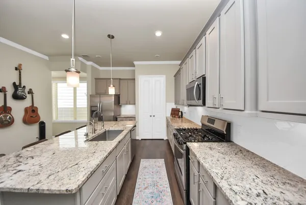 a large kitchen with granite countertop lots of counter top space
