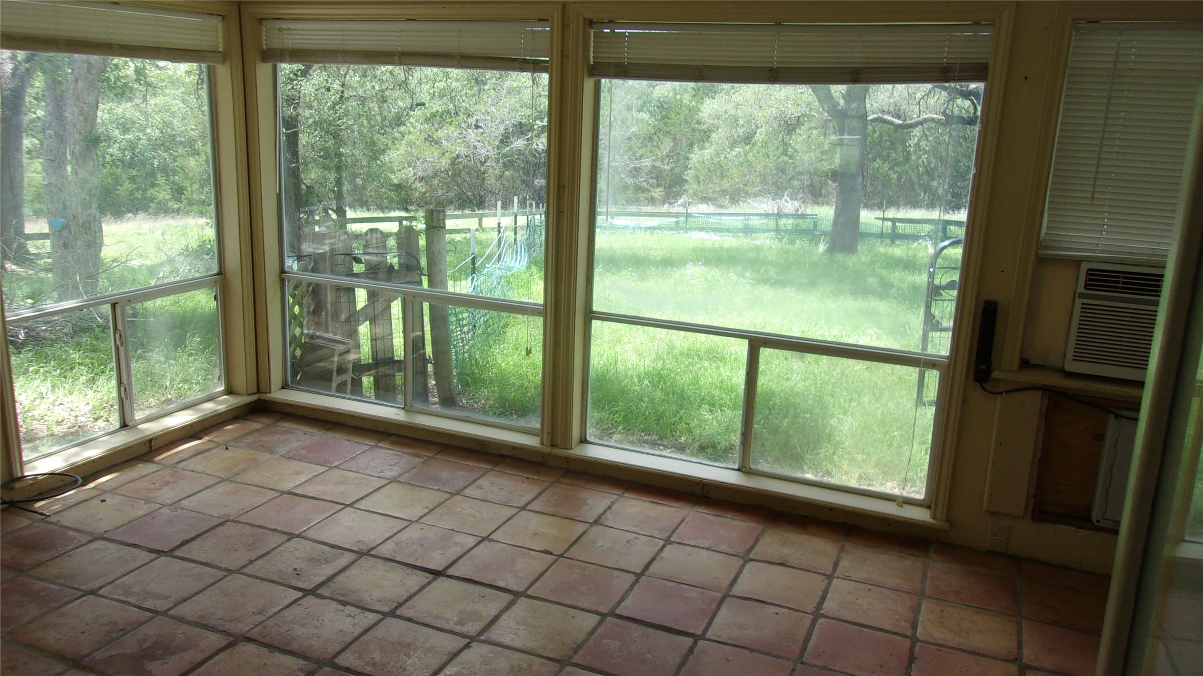 702 Cottonwood Creek Road Dripping Springs, TX 78620 - Photo 20 of 31 Sunroom featuring terracotta-style floor tiles and multiple large windows