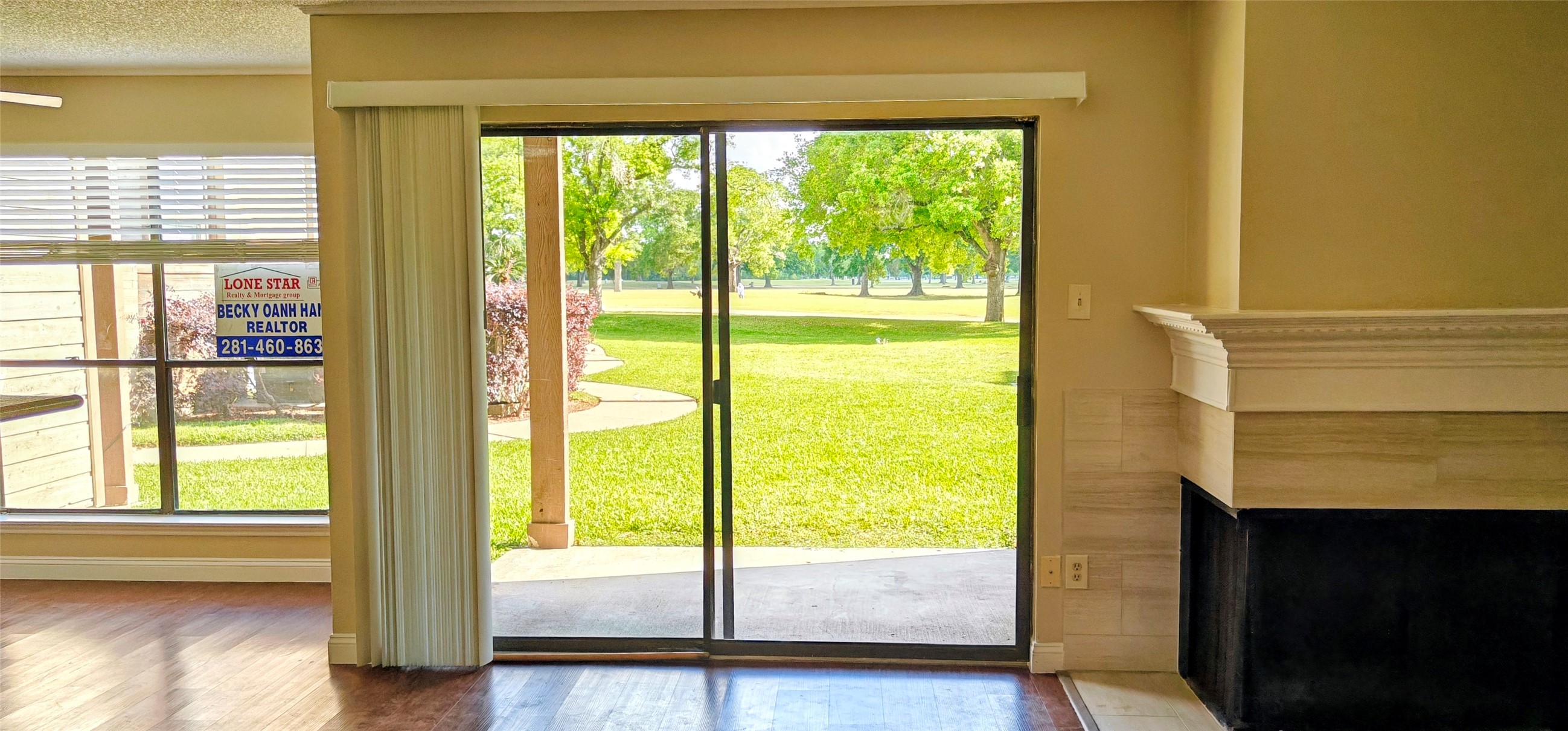 8413 Sands Point Drive Houston, TX 77036 - Photo 13 of 23 a view of an empty room with wooden floor and windows