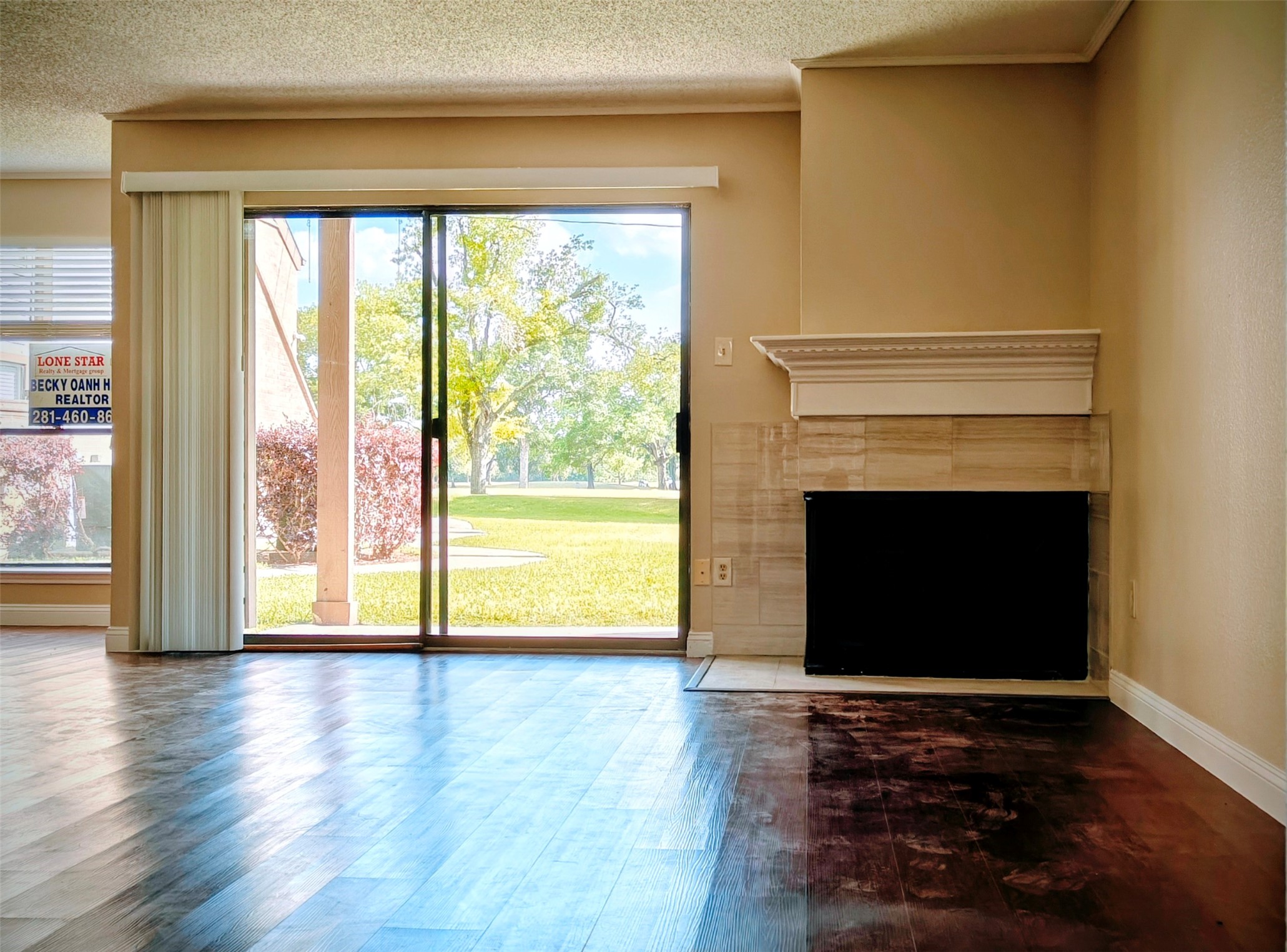 8413 Sands Point Drive Houston, TX 77036 - Photo 2 of 23 a view of an empty room with wooden floor and a fireplace