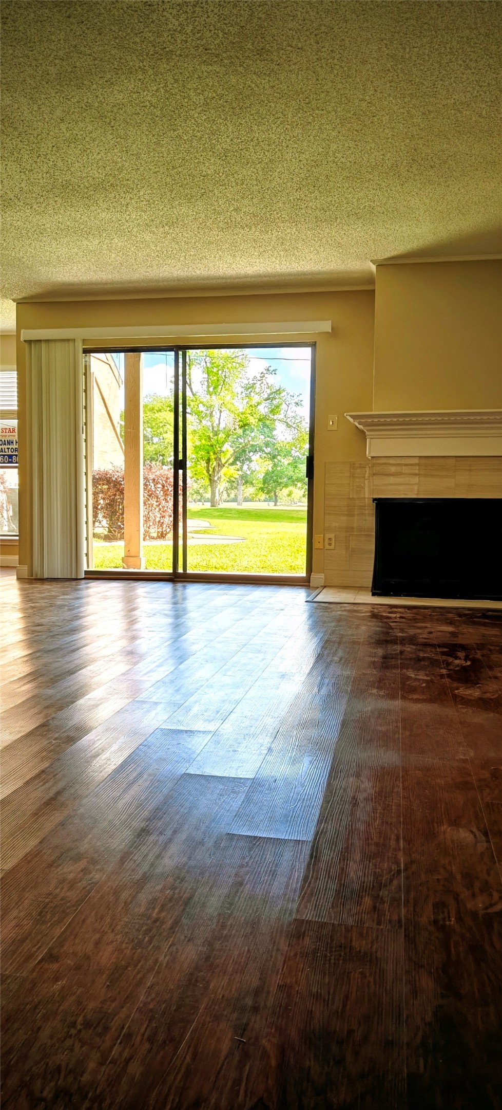 8413 Sands Point Drive Houston, TX 77036 - Photo 3 of 23 a view of empty room with wooden floor and fireplace