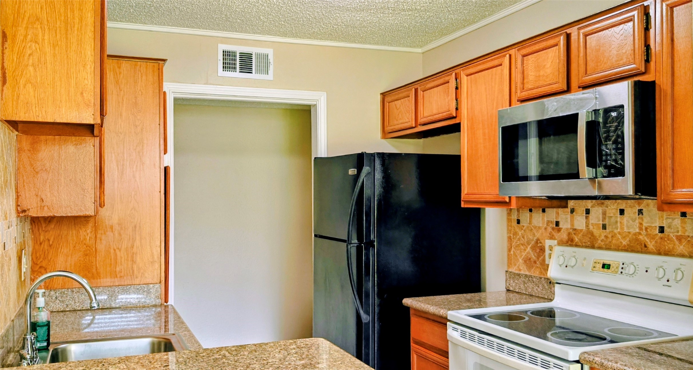 8413 Sands Point Drive Houston, TX 77036 - Photo 8 of 23 a kitchen with stainless steel appliances granite countertop a refrigerator and a stove top oven