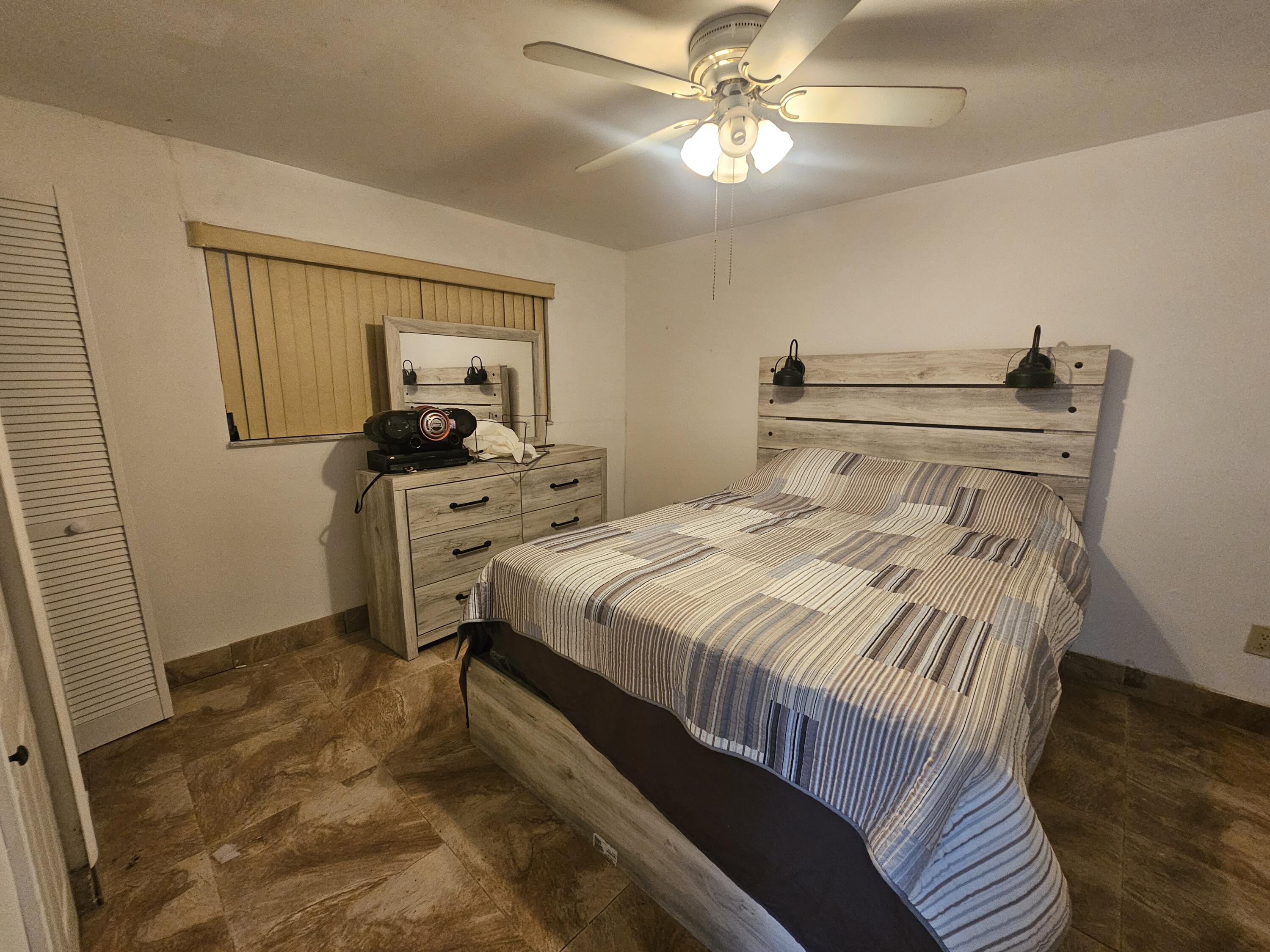 174 Corrine Place Key Largo, FL 33037 - Photo 11 of 28 a bedroom with a bed and a chandelier