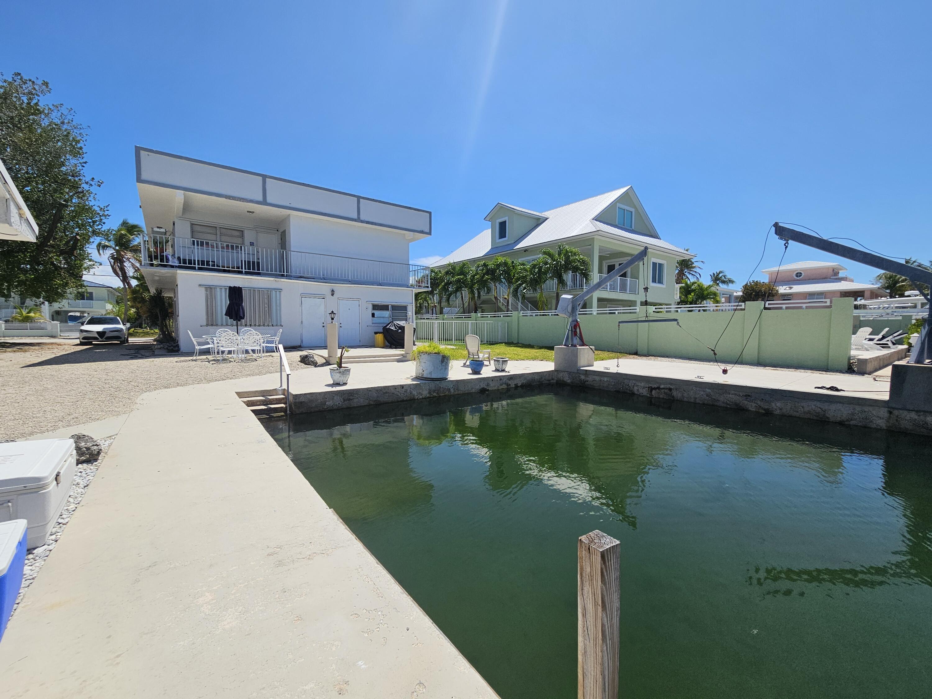 174 Corrine Place Key Largo, FL 33037 - Photo 16 of 28 a view of a lake with couches and lounge chairs