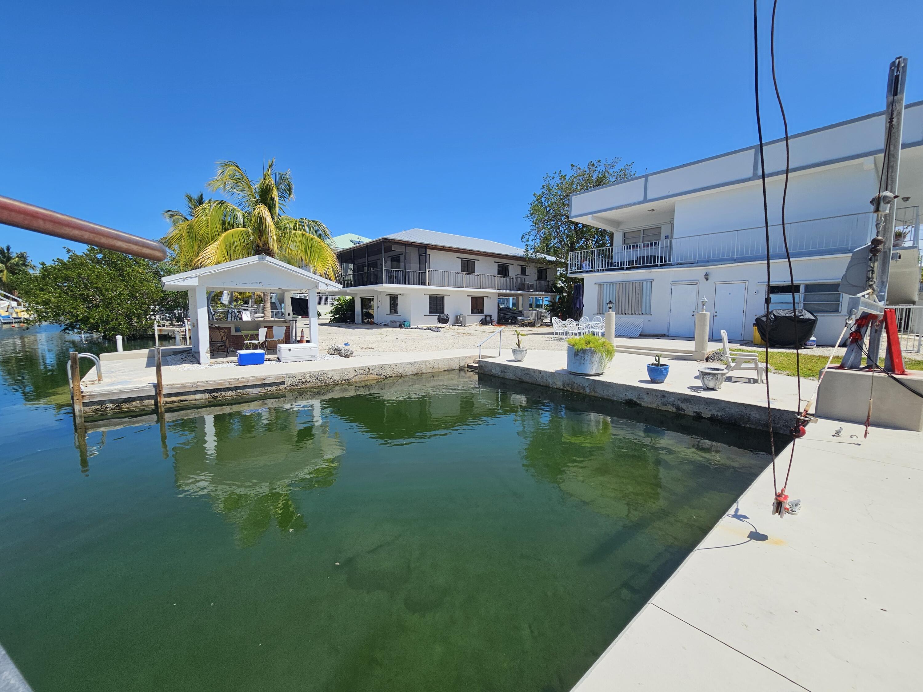 174 Corrine Place Key Largo, FL 33037 - Photo 18 of 28 a swimming pool view with a seating space and a garden view