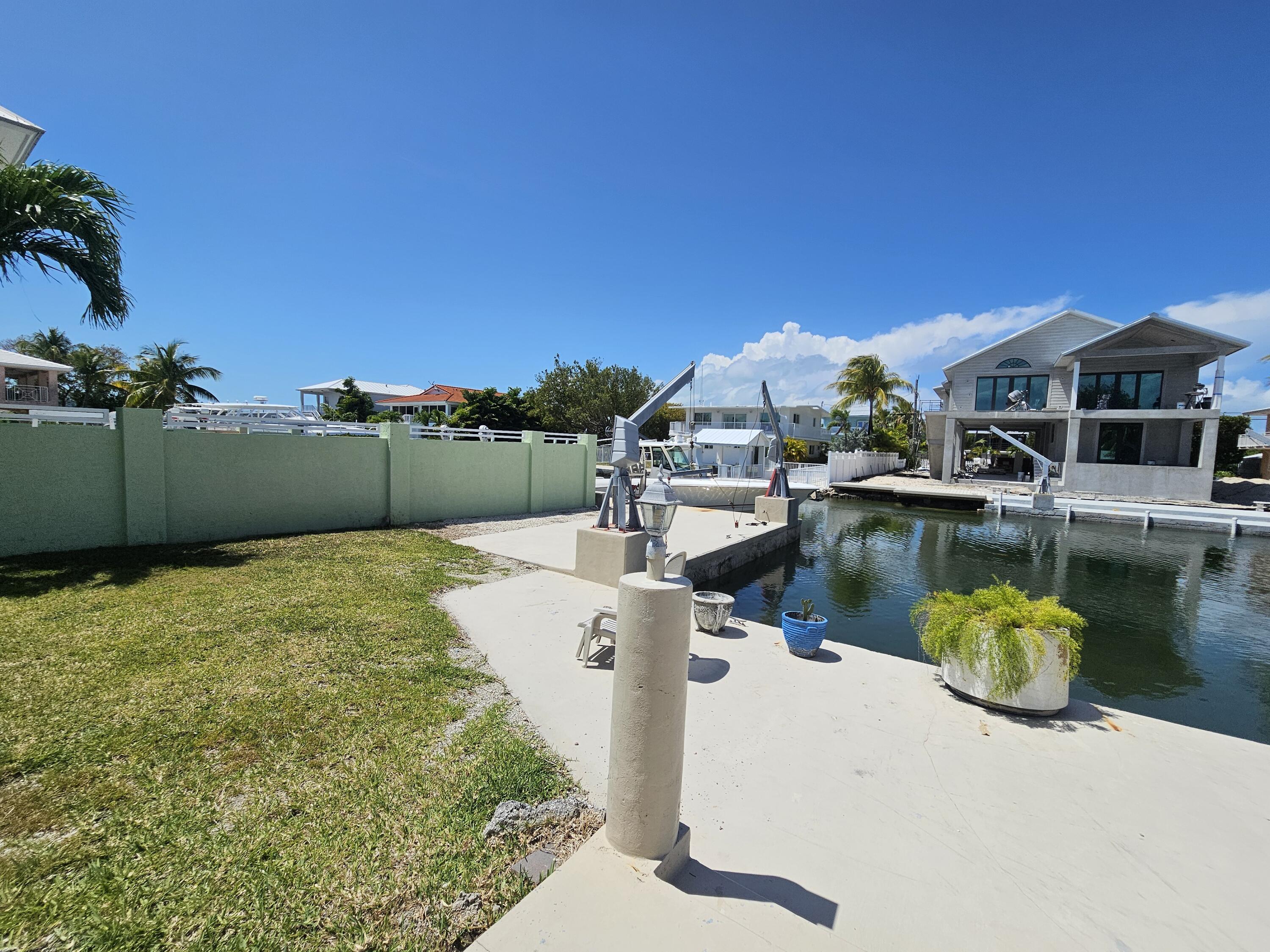 174 Corrine Place Key Largo, FL 33037 - Photo 21 of 28 a view of a lake with a house in the background