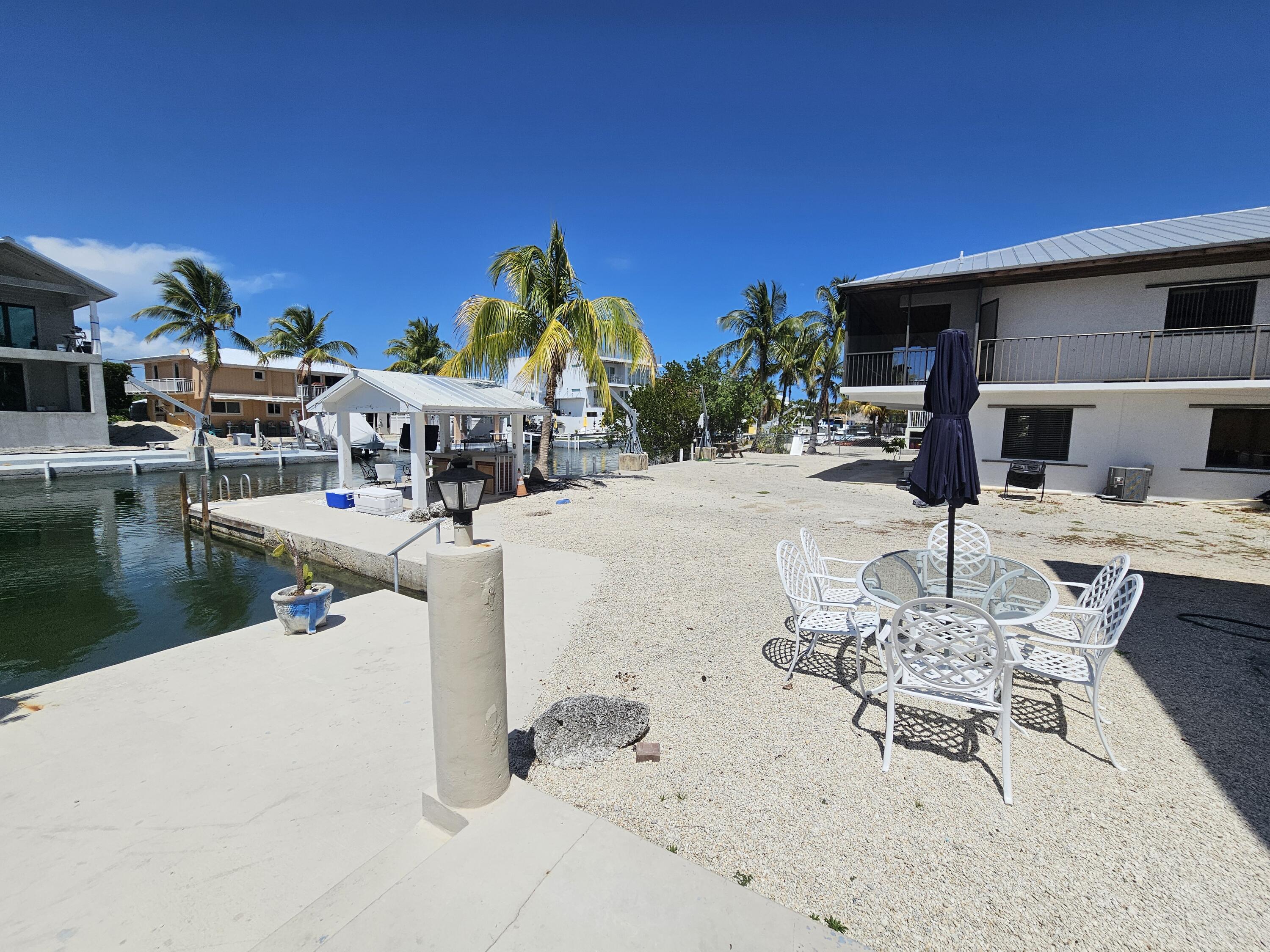 174 Corrine Place Key Largo, FL 33037 - Photo 22 of 28 a view of a swimming pool with outdoor seating