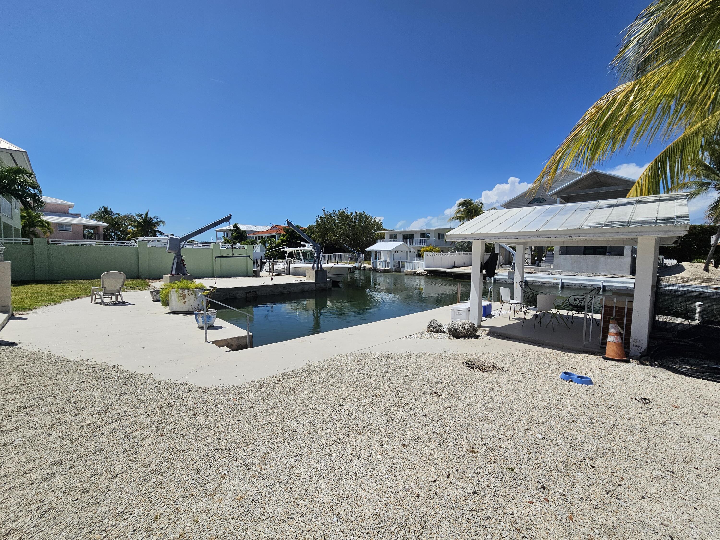 174 Corrine Place Key Largo, FL 33037 - Photo 23 of 28 a view of a swimming pool and lounge chairs