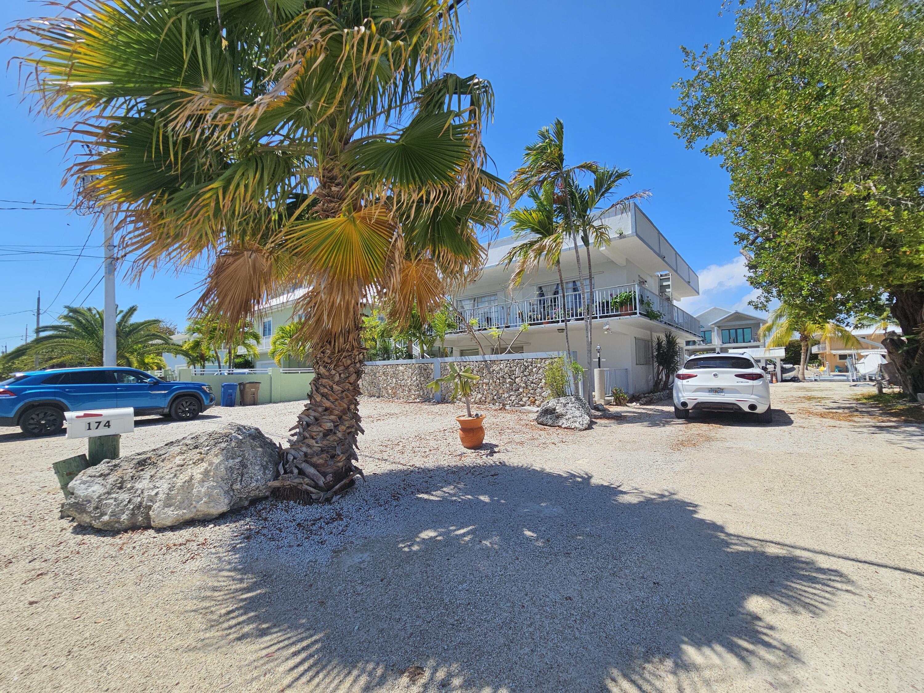174 Corrine Place Key Largo, FL 33037 - Photo 25 of 28 a row of palm trees and a fire pit in the patio