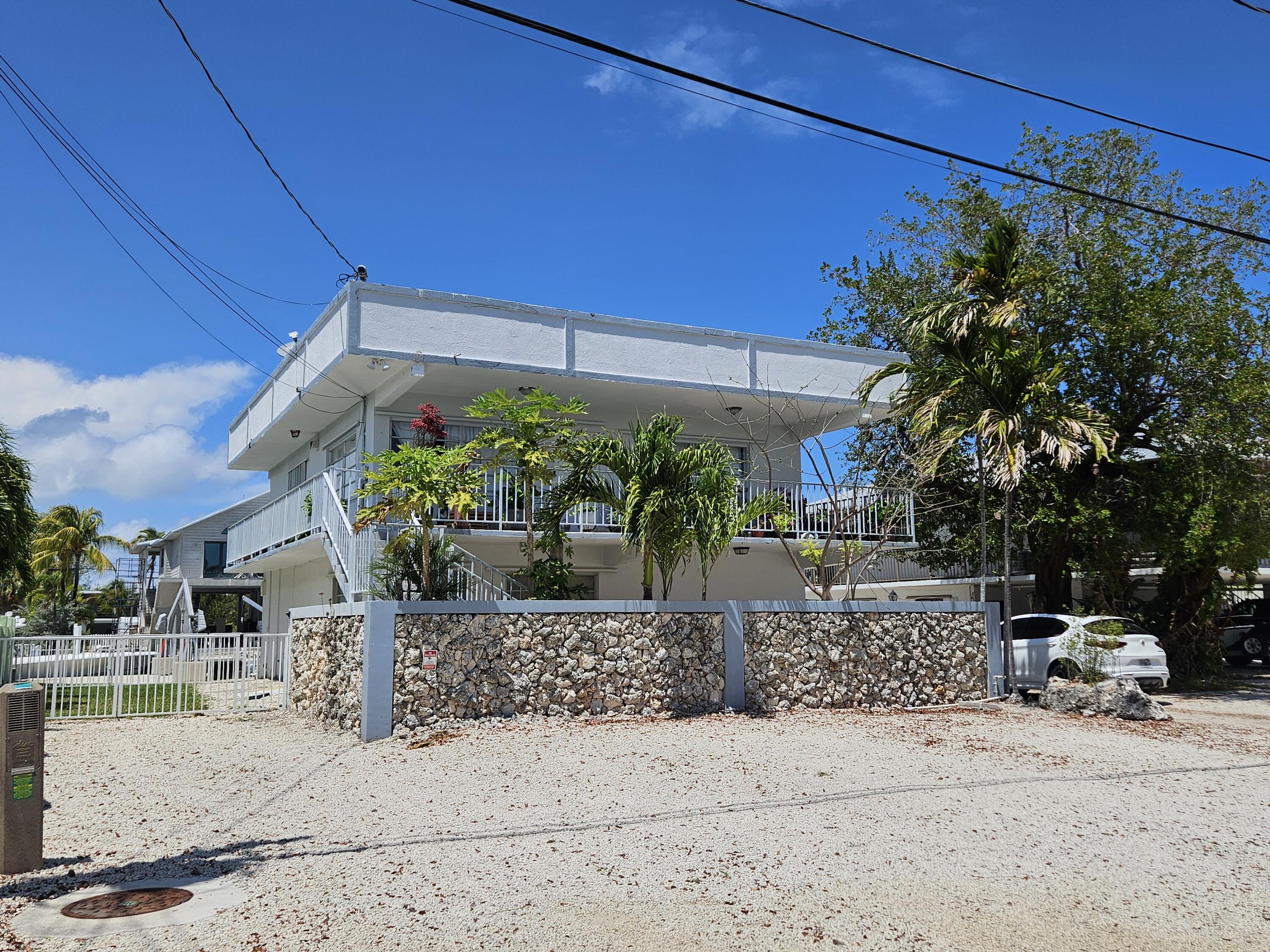 174 Corrine Place Key Largo, FL 33037 - Photo 6 of 28 a view of a street with a building in the background