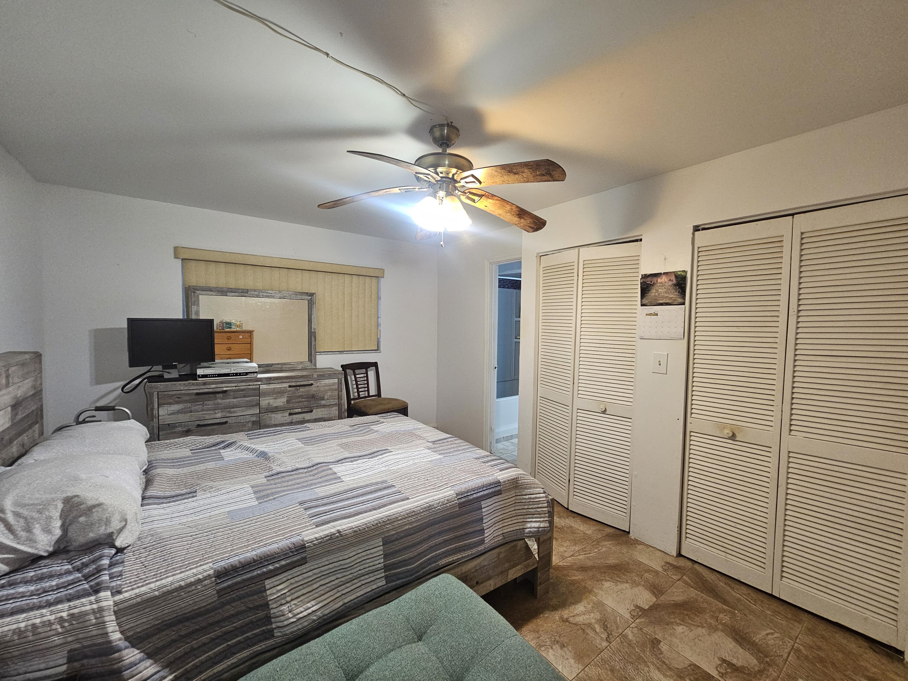 174 Corrine Place Key Largo, FL 33037 - Photo 9 of 28 a bedroom with a bed and a chandelier