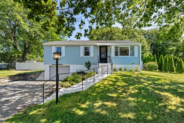 a view of a house with a backyard and a garden