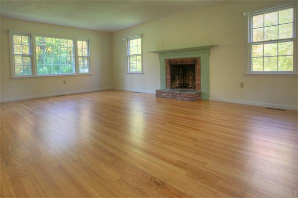 103 Hartland Road Tolland, MA 01034 - Photo 4 of 12 an empty room with wooden floor and windows